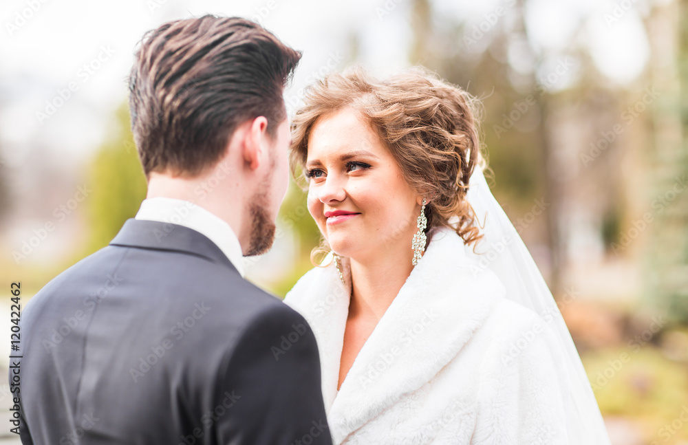 Young wedding couple enjoying romantic moments outside on autumn nature Young wedding couple enjoying romantic moments outside on autumn nature