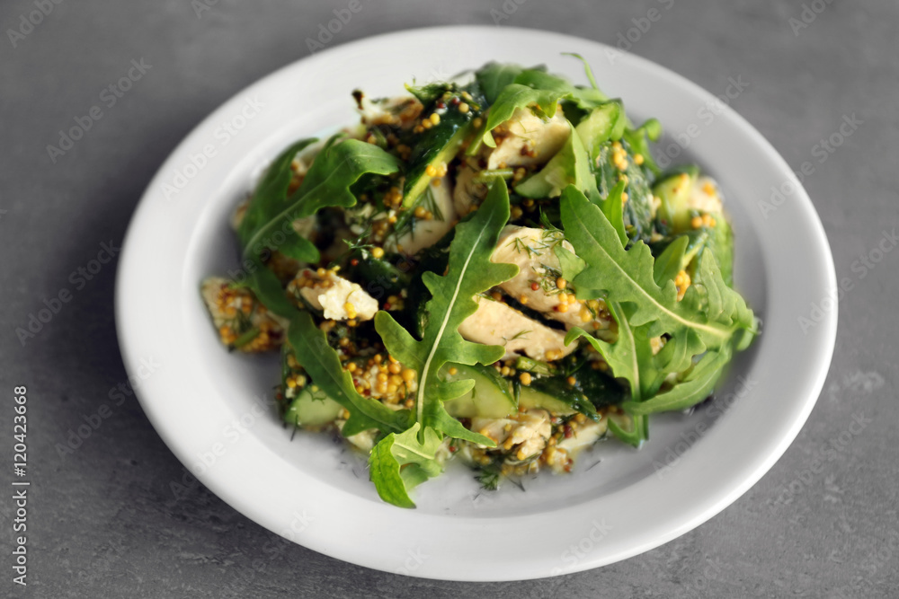 Tasty salad with chicken, cucumbers and arugula on plate Tasty salad with chicken, cucumbers and arugula on plate