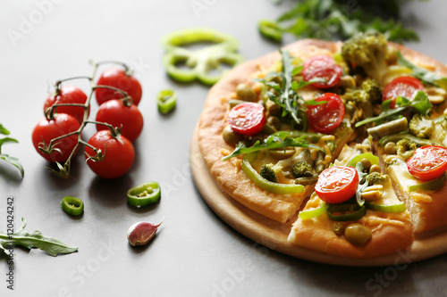 Plate with tasty vegetarian pizza on table
