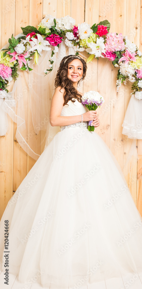 Beautiful bride in white wedding dress with bridal bouquet Beautiful bride in white wedding dress with bridal bouquet