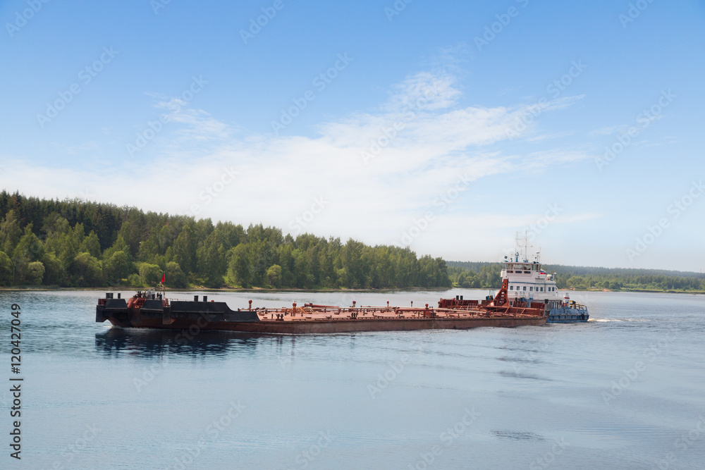 River tugboat moves barge on the Volga River