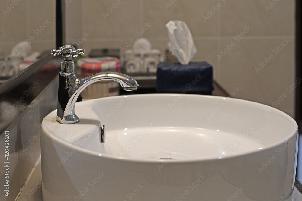 Fototapeta premium ceramic washbasin and metal faucet