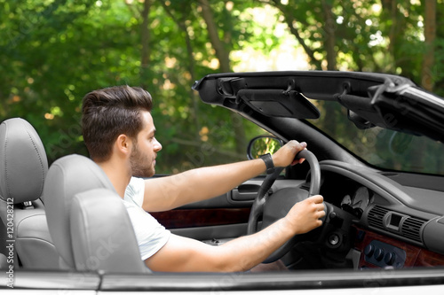 Man driving car on road trip