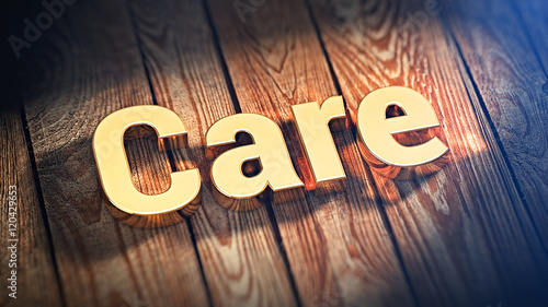 Fotografie Word Care on wood planks
