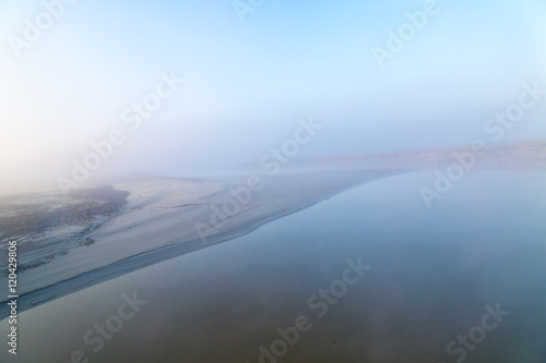Foggy coast of Normandy in sunrise, light spectacle 