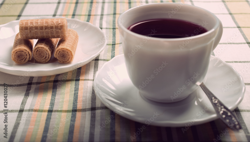 standing on the table white Cup with a tea of hibiscus. Vintage standing on the table white Cup with a tea of hibiscus. Vintage