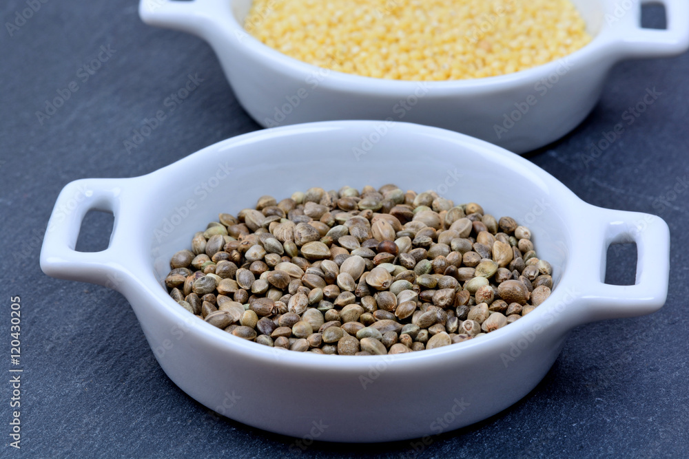 Hemp seeds with millet seeds in a ceramic bowls Hemp seeds with millet seeds in a ceramic bowls