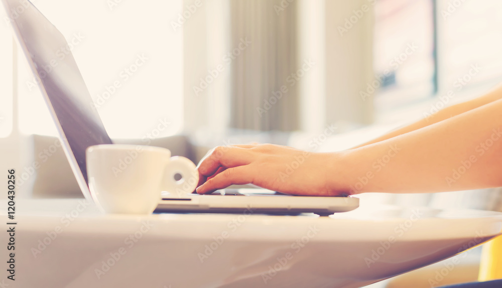 Hands typing on thin laptop computer Hands typing on thin laptop computer