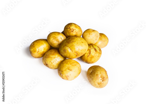 beautiful pile of small rounded whole organic potatoes with the peel isolated on a white background with focal blur