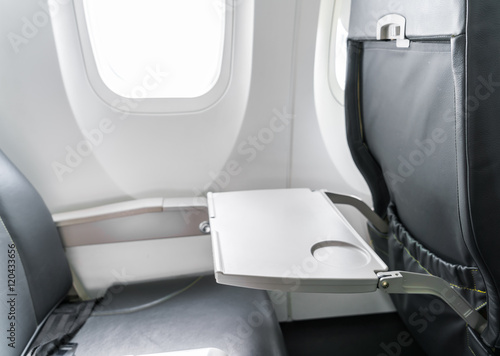 Airplane tray table on seat back .