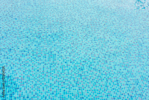 Blue swimming pool rippled water . © jannoon028