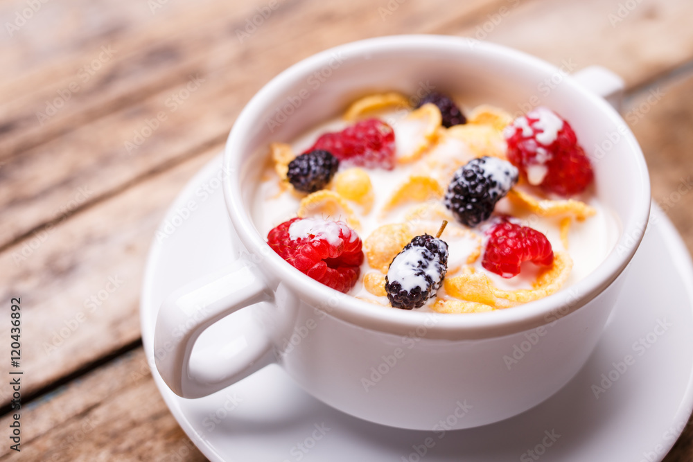 Close up image of corn flakes with berry and milk Close up image of corn flakes with berry and milk