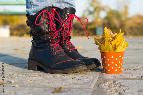Hello, autumn. Small bucket in female hand. bucket with fallen autumn leaves. yellow fallen leaves in autumn park. 