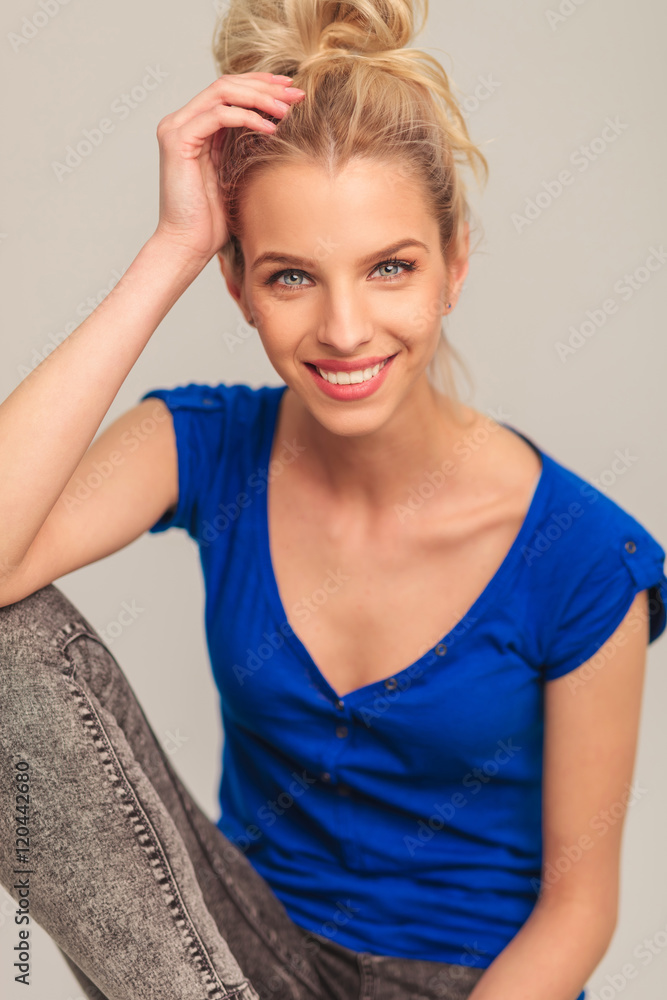 Fototapeta premium laughing young blonde woman sitting