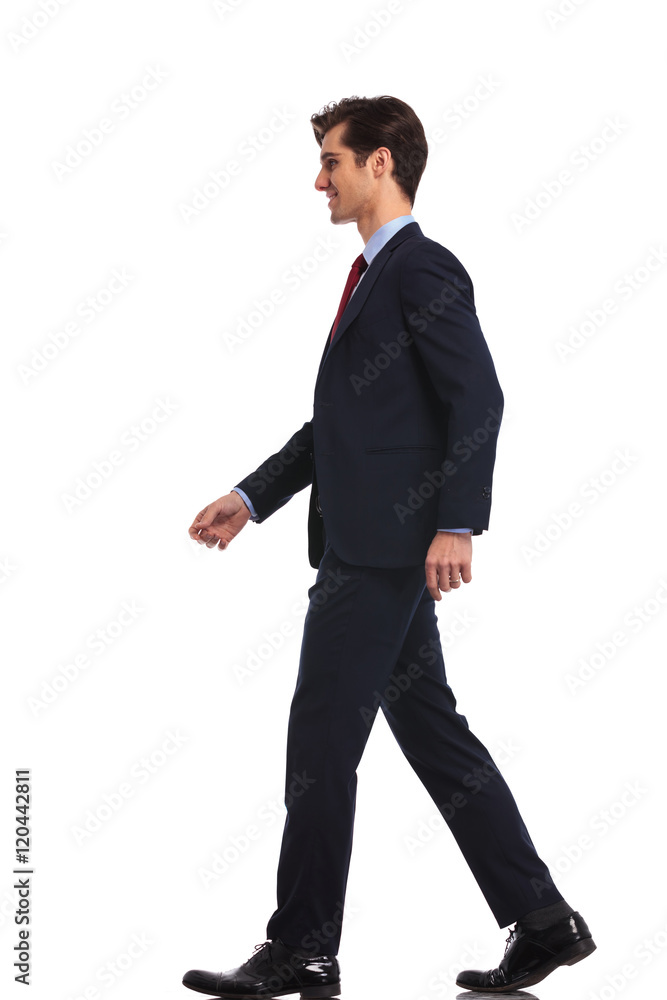 side view of a walking young business man side view of a walking young business man