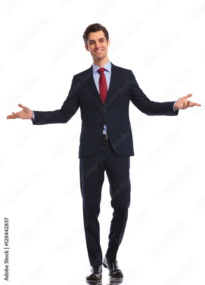 smiling young business man in suit and tie welcoming you smiling young business man in suit and tie welcoming you