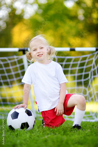 Cute little soccer player having fun playing a soccer game