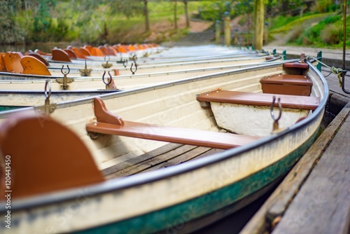 Small wooden row boats from the side at Fairfield Boathouse in Victoria Australia