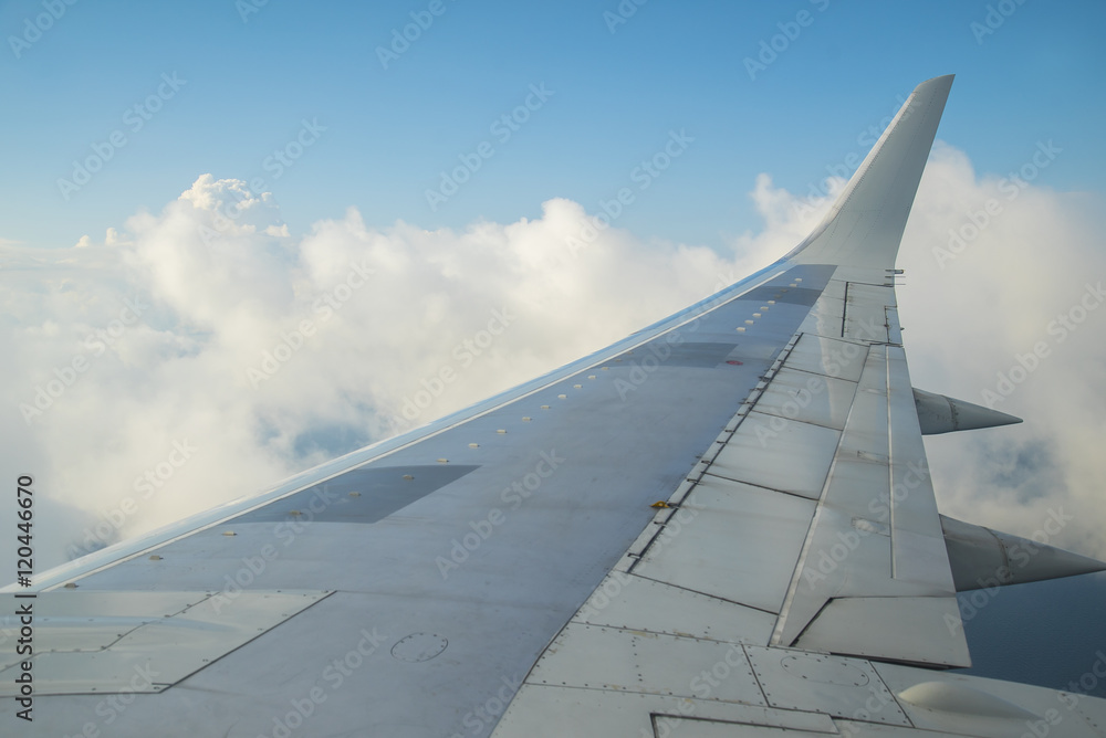 Aerial view of cloudy blue sky from aircraft windows