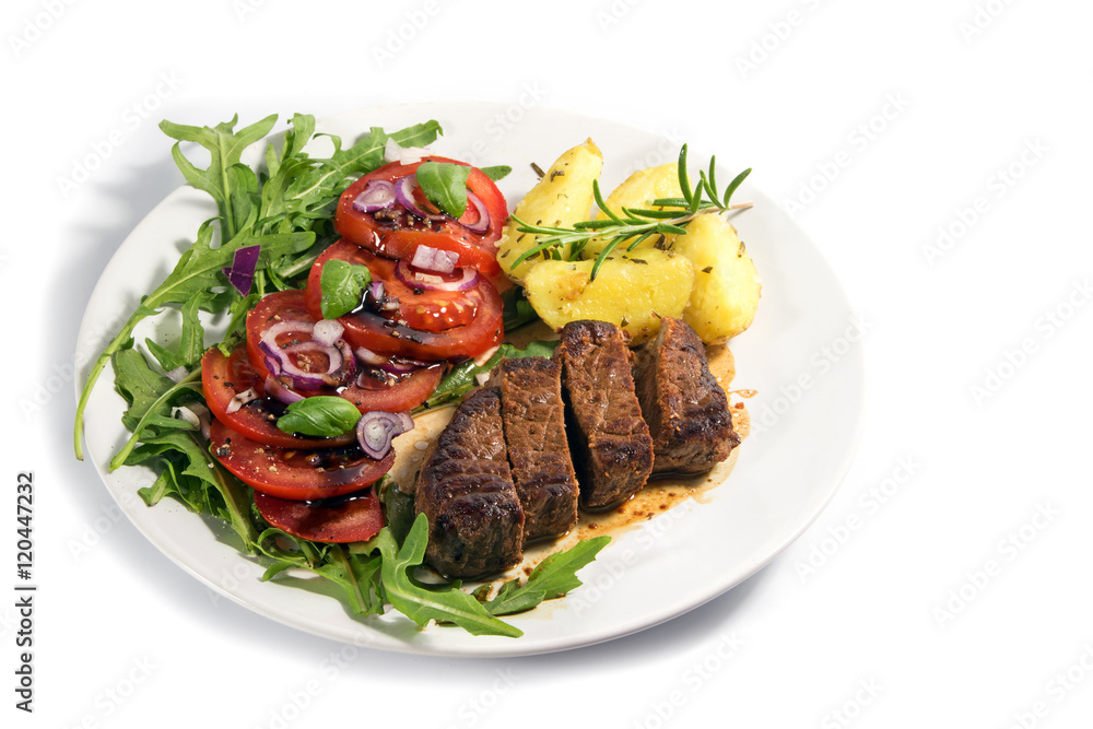 roasted beef filet mignon with potatoes and tomato arugula salad isolated on white roasted beef filet mignon with potatoes and tomato arugula salad isolated on white