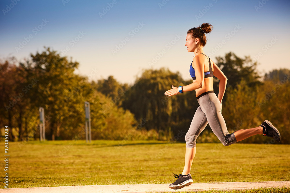 Athletic woman running in park