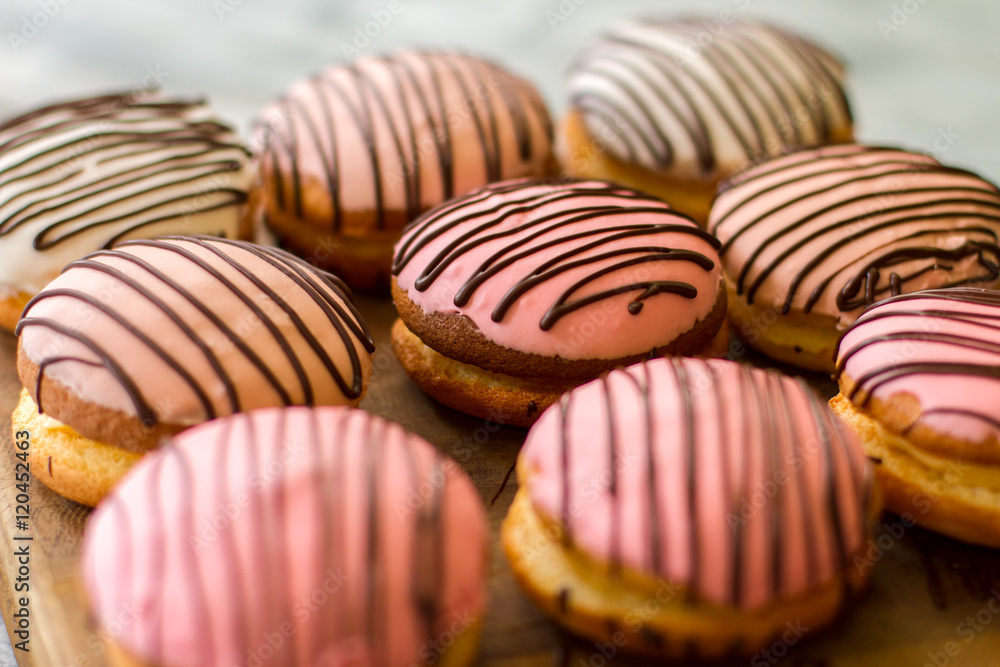 Cookies with pink icing. Decorated biscuits on wooden board. Tasty bush cakes for dessert. Best sweets at low price. Cookies with pink icing. Decorated biscuits on wooden board. Tasty bush cakes for dessert. Best sweets at low price.