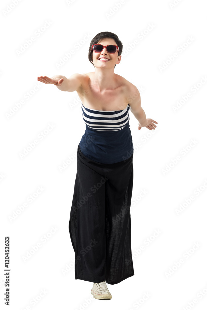Playful happy short hair brunette standing on one leg pretending to fly. Full body length portrait isolated over white studio background. Playful happy short hair brunette standing on one leg pretending to fly. Full body length portrait isolated over white studio background.