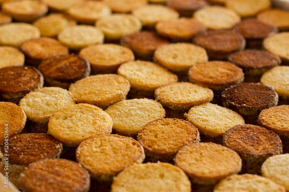 Rows of cookies. Brown and yellow biscuits. Production of desserts. Only top quality components. Rows of cookies. Brown and yellow biscuits. Production of desserts. Only top quality components.