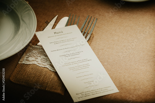 Wedding menu card over table setting. Event detail. 