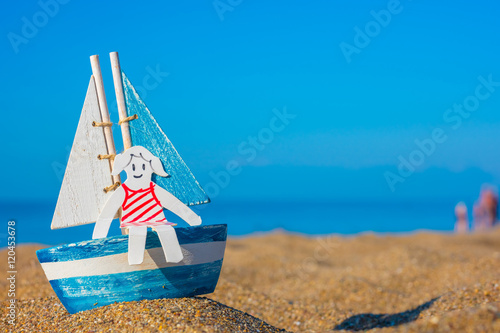 paper cut of girl on sailboat on the beach © Myst