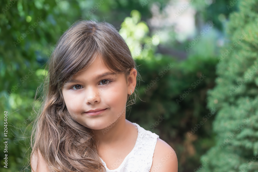 Portrait of smiling attractive little girl outdoors. Girl is lookinf at the camera. Portrait of smiling attractive little girl outdoors. Girl is lookinf at the camera.