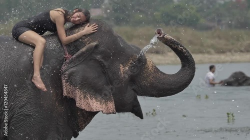 Girl have a shower on the elephant