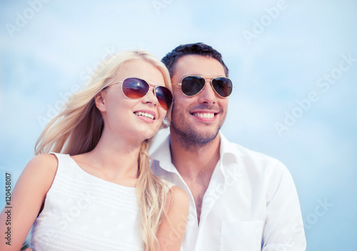 couple in shades at sea side © Syda Productions