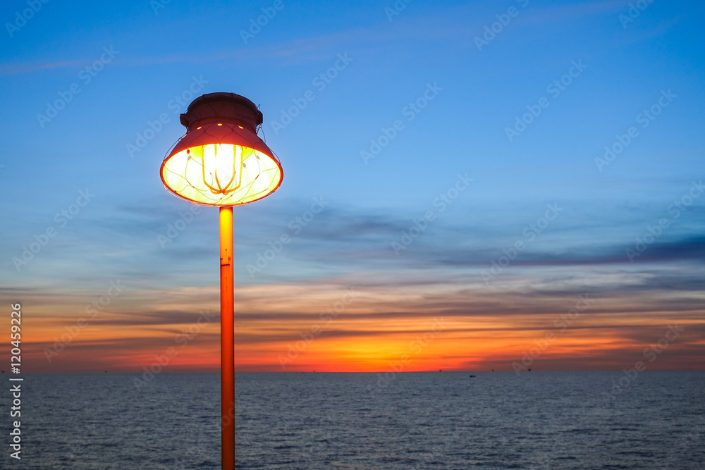Lighting of warm lamp and lighting of sunset at sea.