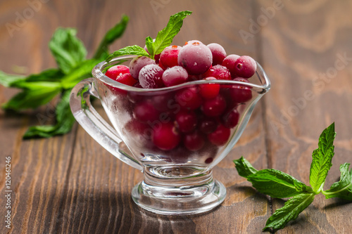 Frozen cranberries in a glass bowl 