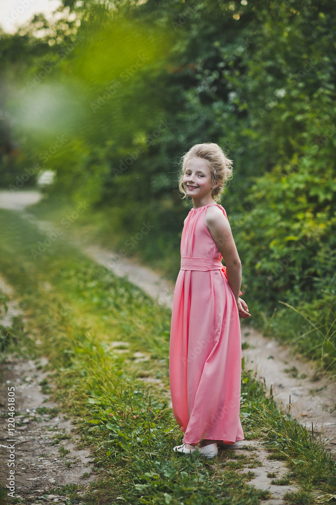 A beautiful portrait of a girl in evening dress among the garden A beautiful portrait of a girl in evening dress among the garden