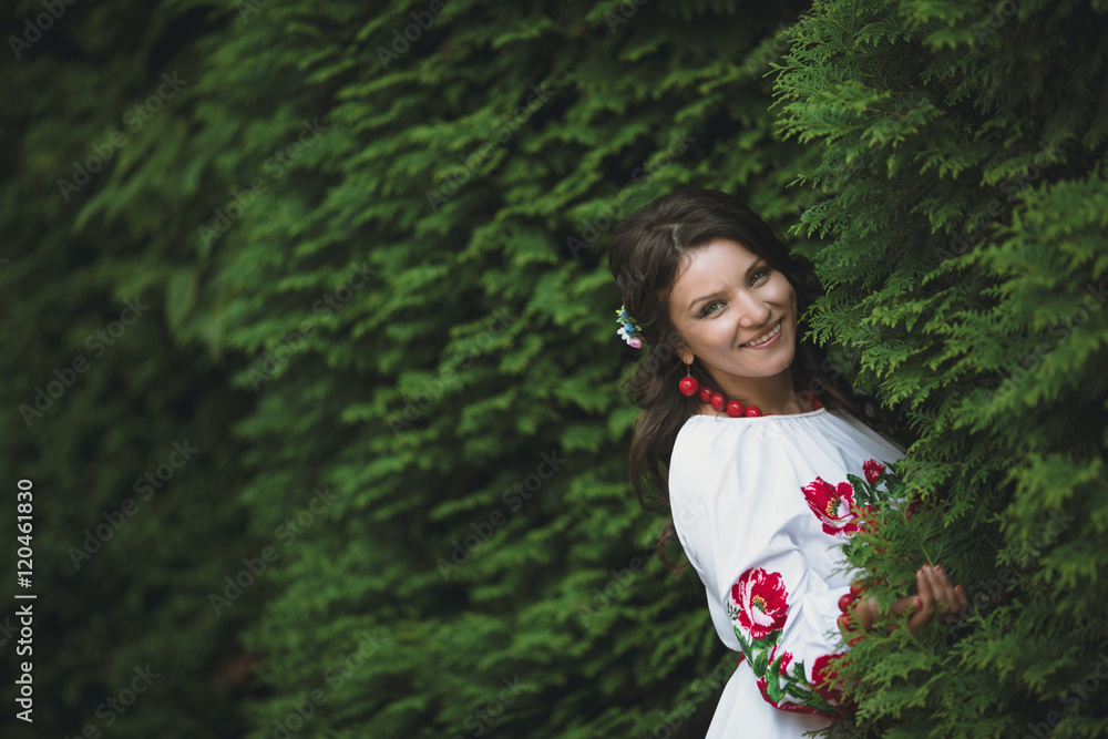 young woman in embroidered shirts standing in the park young woman in embroidered shirts standing in the park