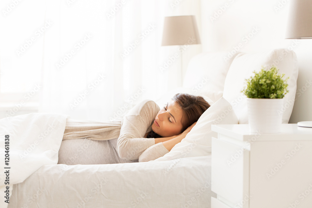 happy pregnant woman sleeping in bed at home happy pregnant woman sleeping in bed at home