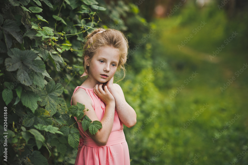 A childs portrait set amidst a blossomed garden 6661.