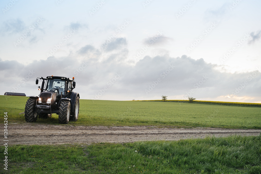 Tractor on grassy field against sky Tractor on grassy field against sky