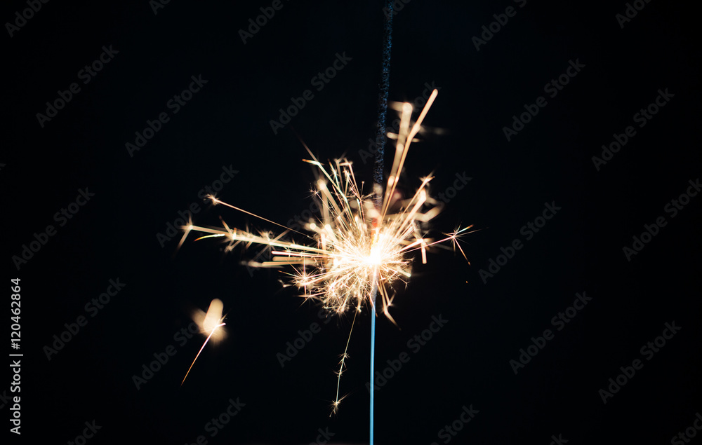 sparkler burning over black background sparkler burning over black background