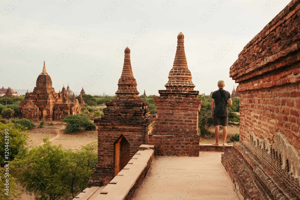 Fototapeta premium Tourist is watching sunrise on pagoda in Bagan