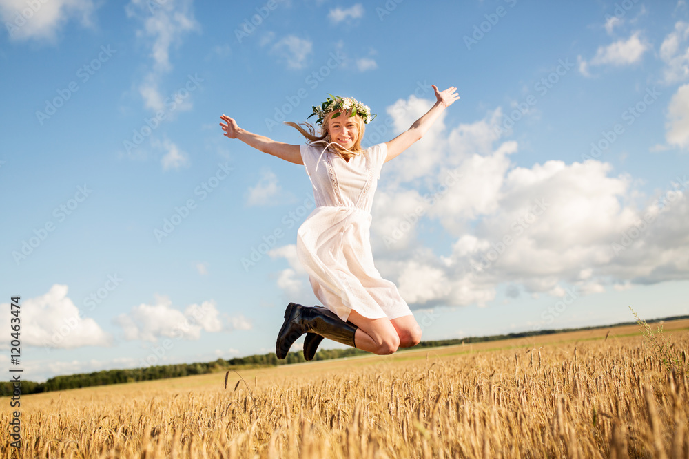 happy woman in wreath jumping on cereal field happy woman in wreath jumping on cereal field
