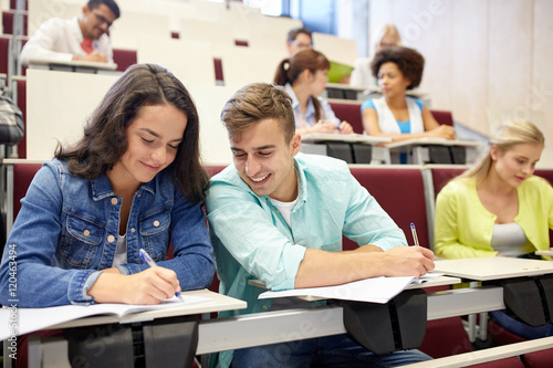 group of students with notebooks at lecture hall