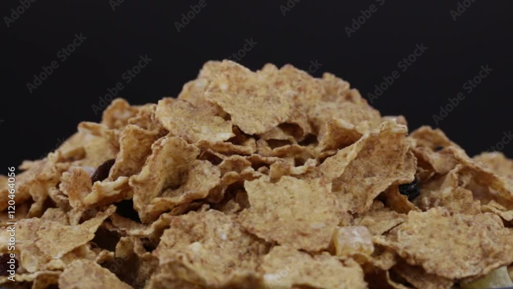 Granola cereal, nuts and raisins rotating . Crunchy tasty muesli food background close-up. Cereals and dried food mixed for breakfast. Granola cereal, nuts and raisins rotating . Crunchy tasty muesli food background close-up. Cereals and dried food mixed for breakfast.