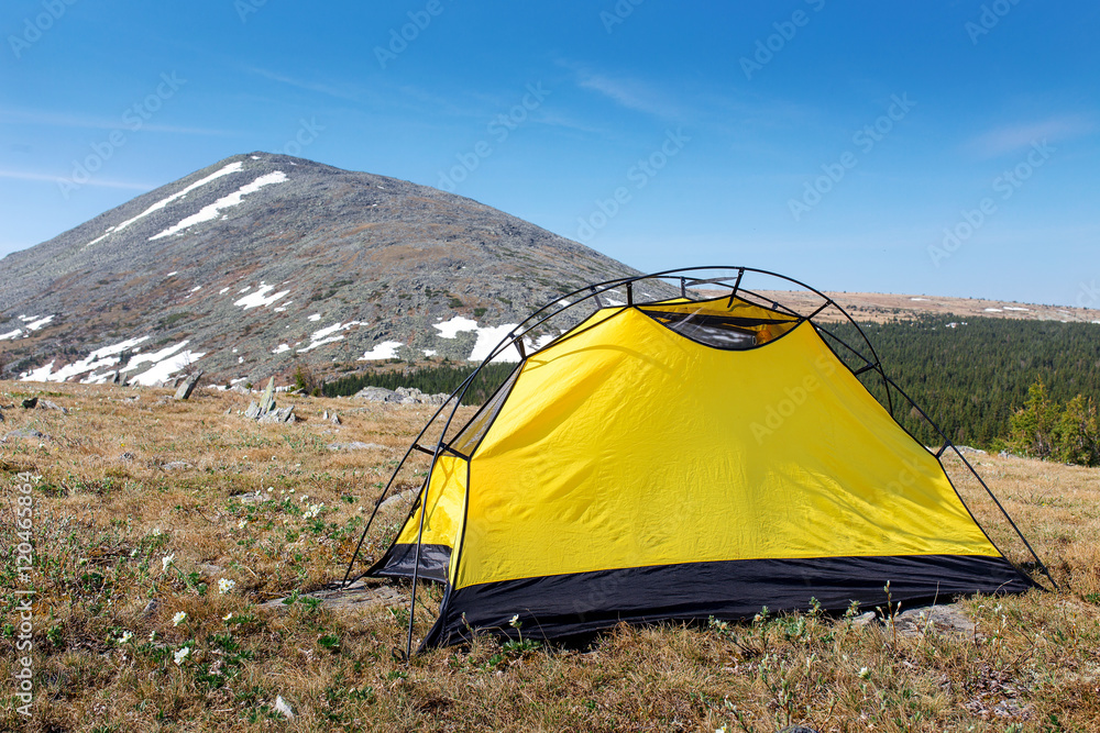 Camping with yellow tent on a sunny day