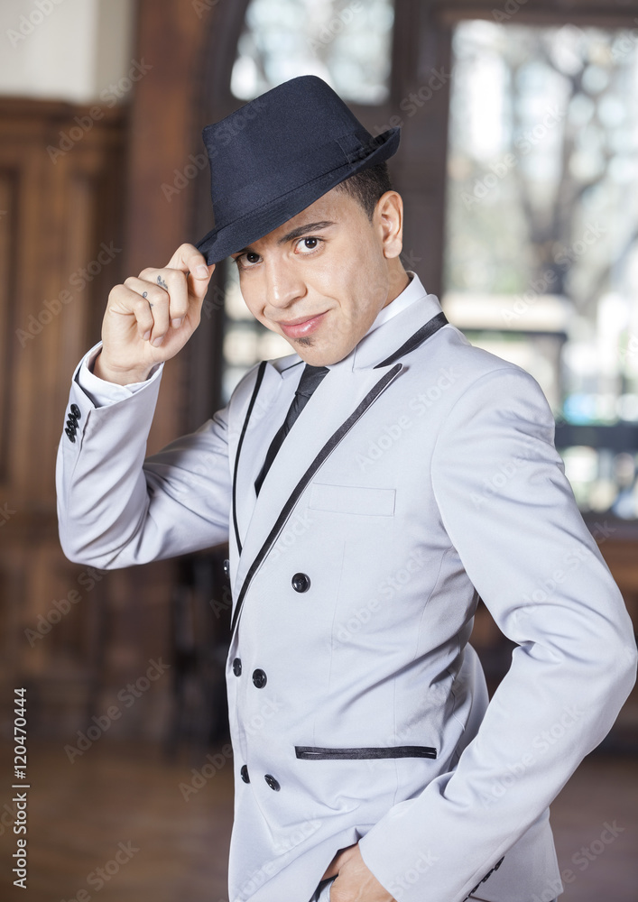 Confident Man Holding Hat While Performing Tango