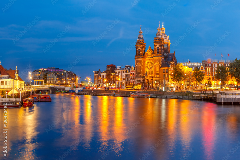 Night panoramic city view of Amsterdam canal, bridge and Basilica of Saint Nicholas, Holland, Netherlands. Long exposure.