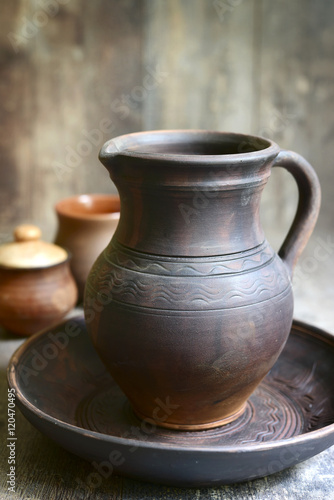 Homemade pottery on a rustic wooden background .