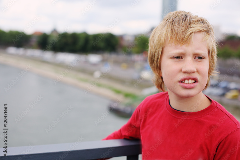 Portrait of cute 8 years old boy standing on the brige Portrait of cute 8 years old boy standing on the brige